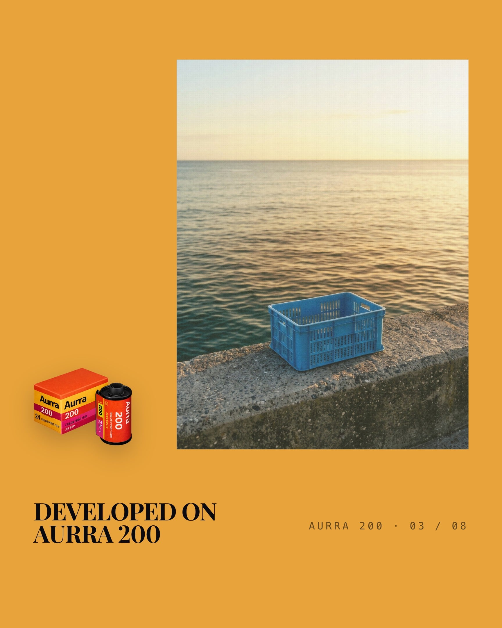 Aurra 200's colour room, an amber yellow, with the picture on the right this time. A blue plastic crate sits on a concrete sea wall, with calm water and a pale sky behind it. The Aurra 200 canister and the line DEVELOPED ON AURRA 200 are on the left.